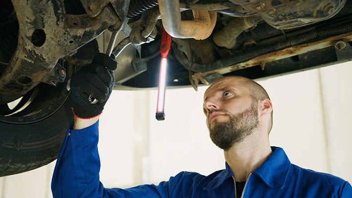 A mechanic using a wench