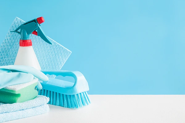 A bunch of cleaning tools in front of a blue background