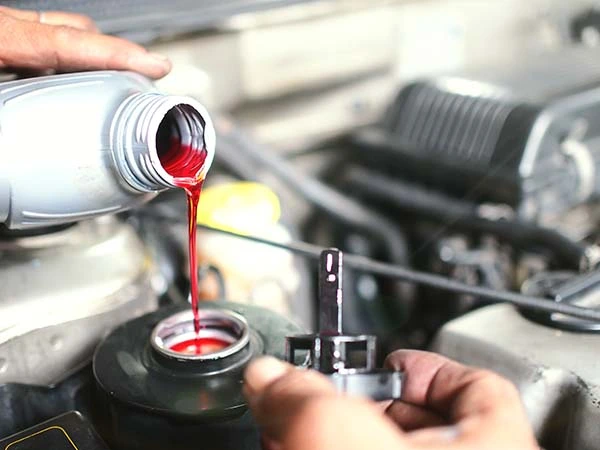 mechanic refilling additional brake fluid