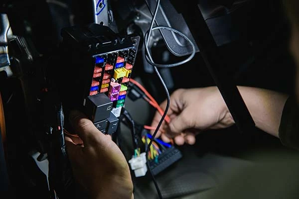 A person holding a block of car fuses