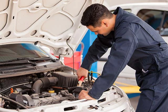 A man adjusting cables and brakes on his car