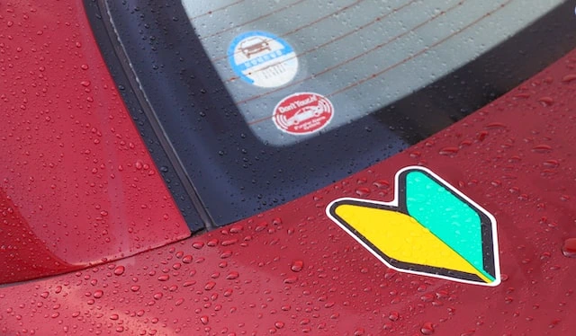 A close-up of some stickers on a red car