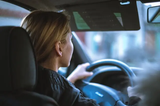 A young woman driving a car