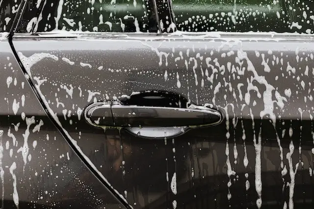 A-closeup-of-a-car-door-with-soap-all-over-it