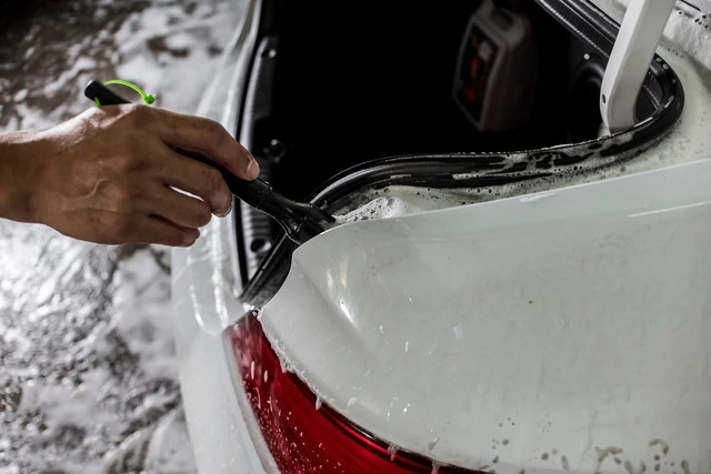 A-man-using-a-brush-and-soapy-water-to-clean