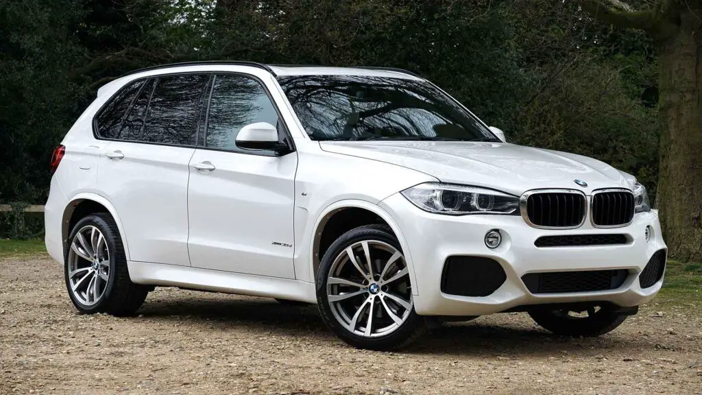 A White BMW X5 parked off-road