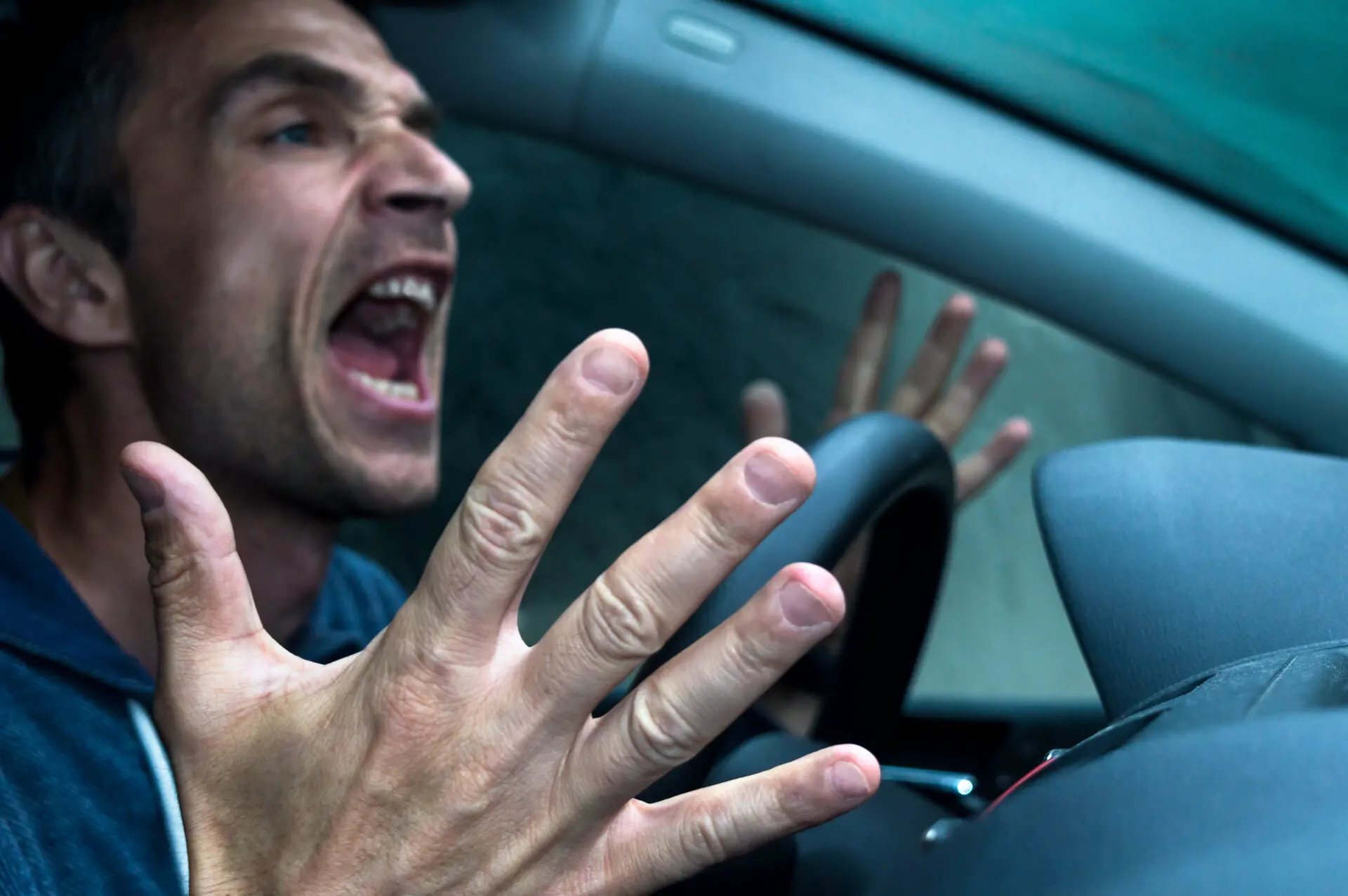 A man yelling while driving