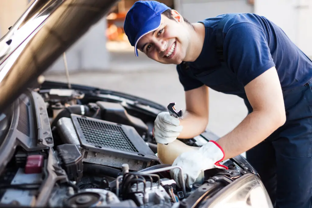 A mechanic looking under the car