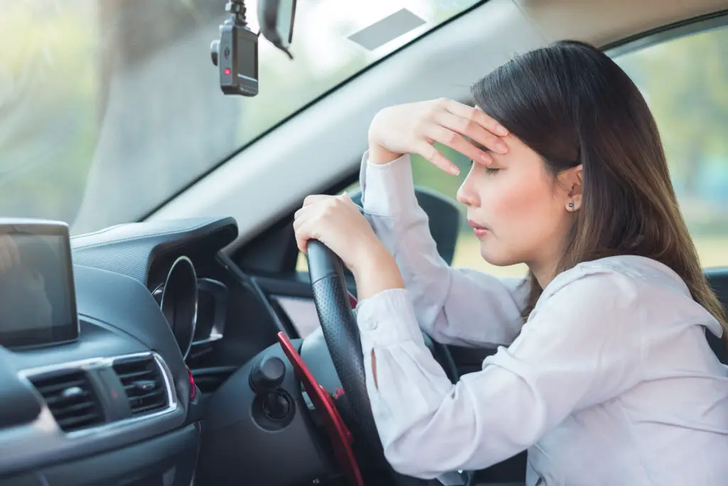 A worried woman in a car