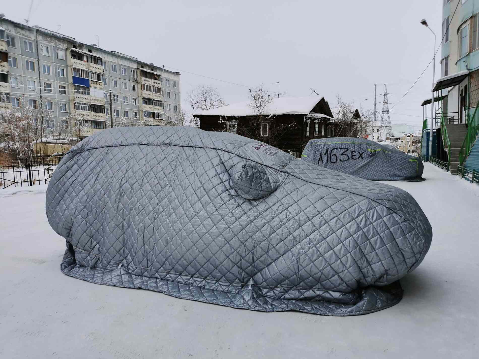 Covered car during the winter and snow