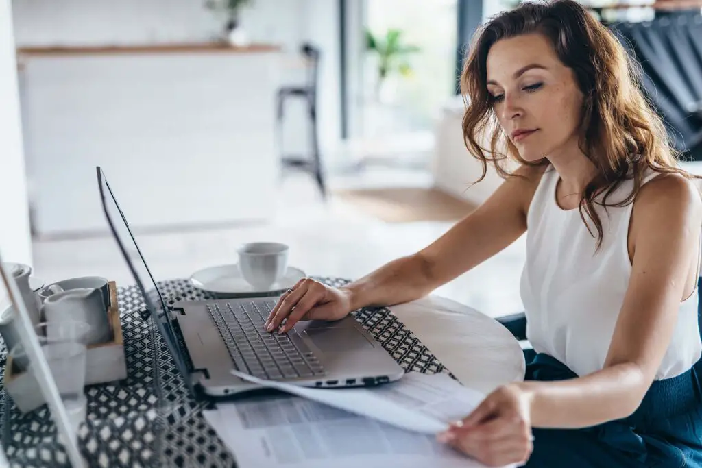 Woman doing research in front of a laptop