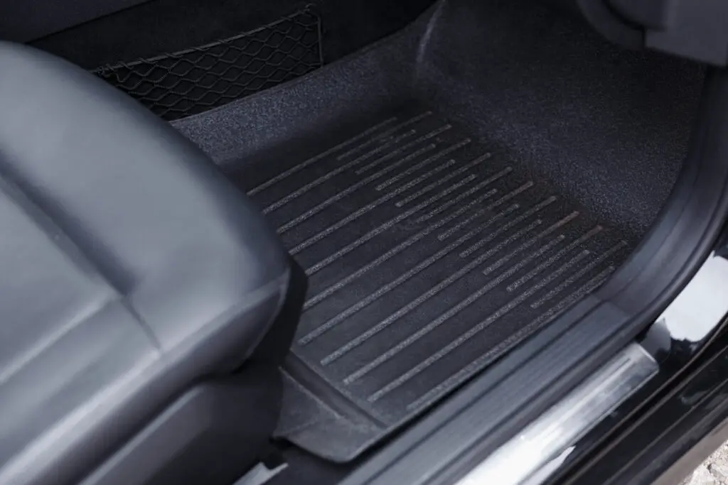  A black rubber floor mat in a car
