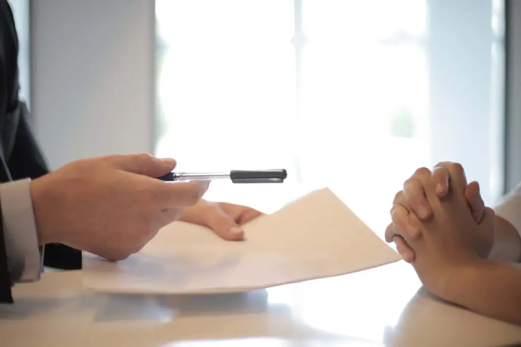 A man being offered a contract to sign