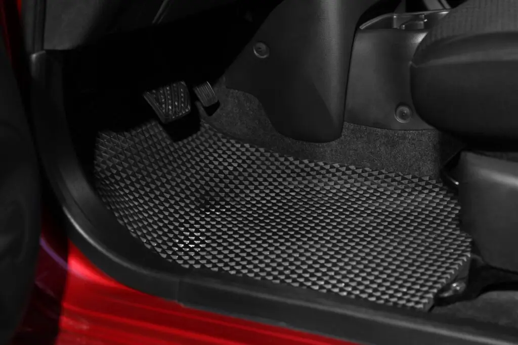  A stylish black car mat in a red car