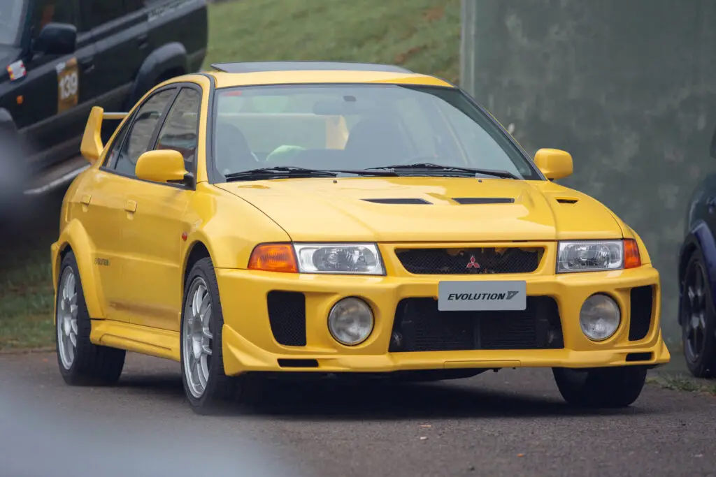 A yellow Mitsubishi Lancer Evolution V car