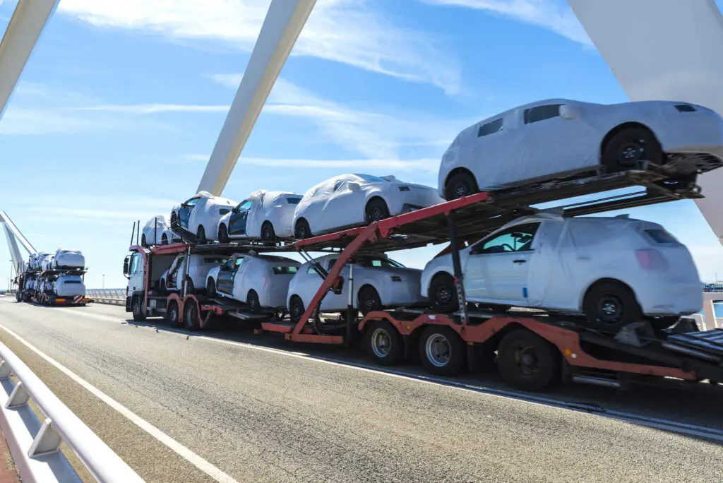 An open truck shipping cars