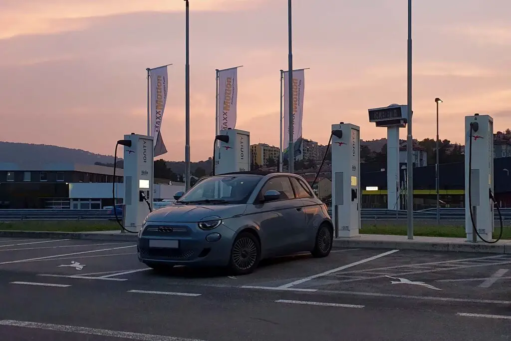 Slovenja Koper 23-10-2022, a blue Fiat 500 electric convertible at a fast charging station charging the battery