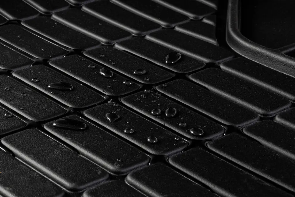 Rubber car mat with water on it