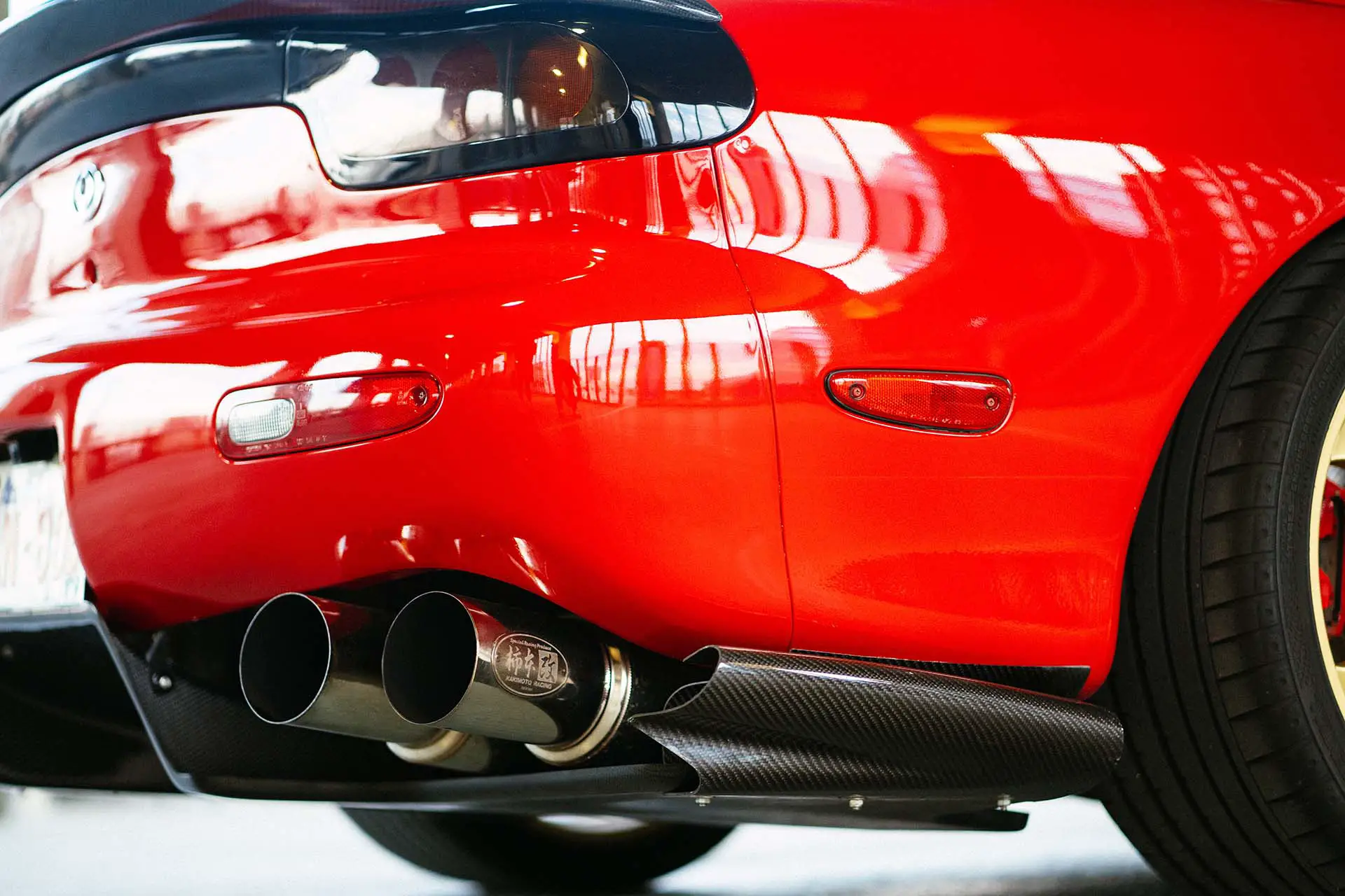 A close-up of the tailpipe on a red car
