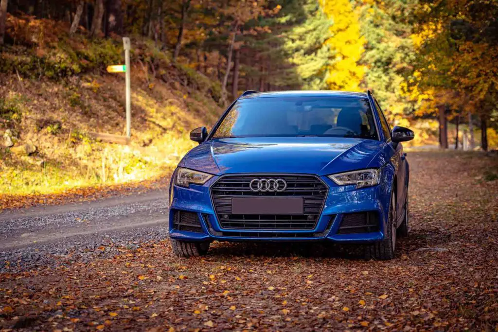 Blue Audi A3 car parked by a road