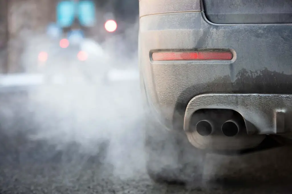 Car exhaust pipe emitting gases