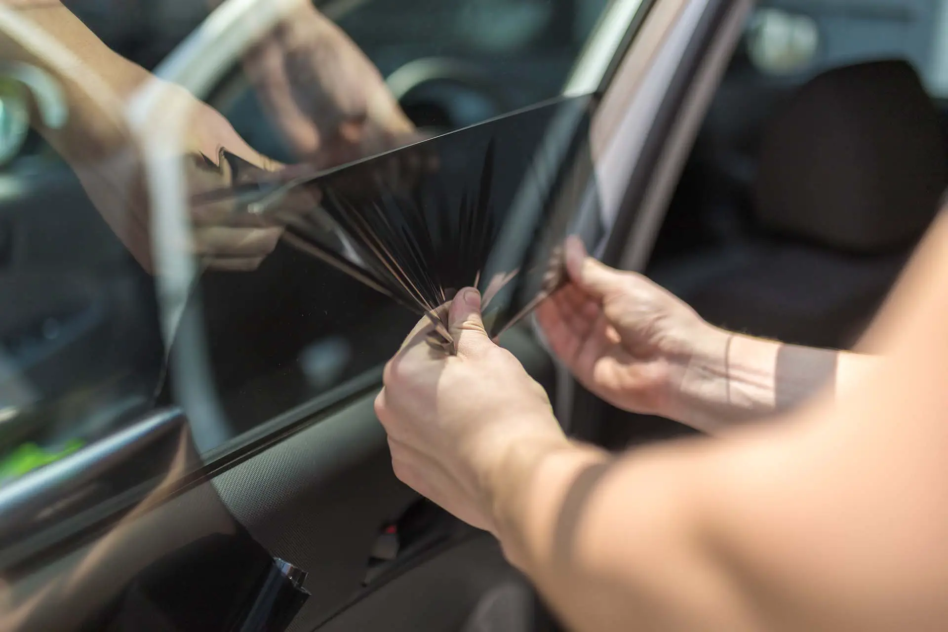 Process of removing sunlight protective car window glass foil.