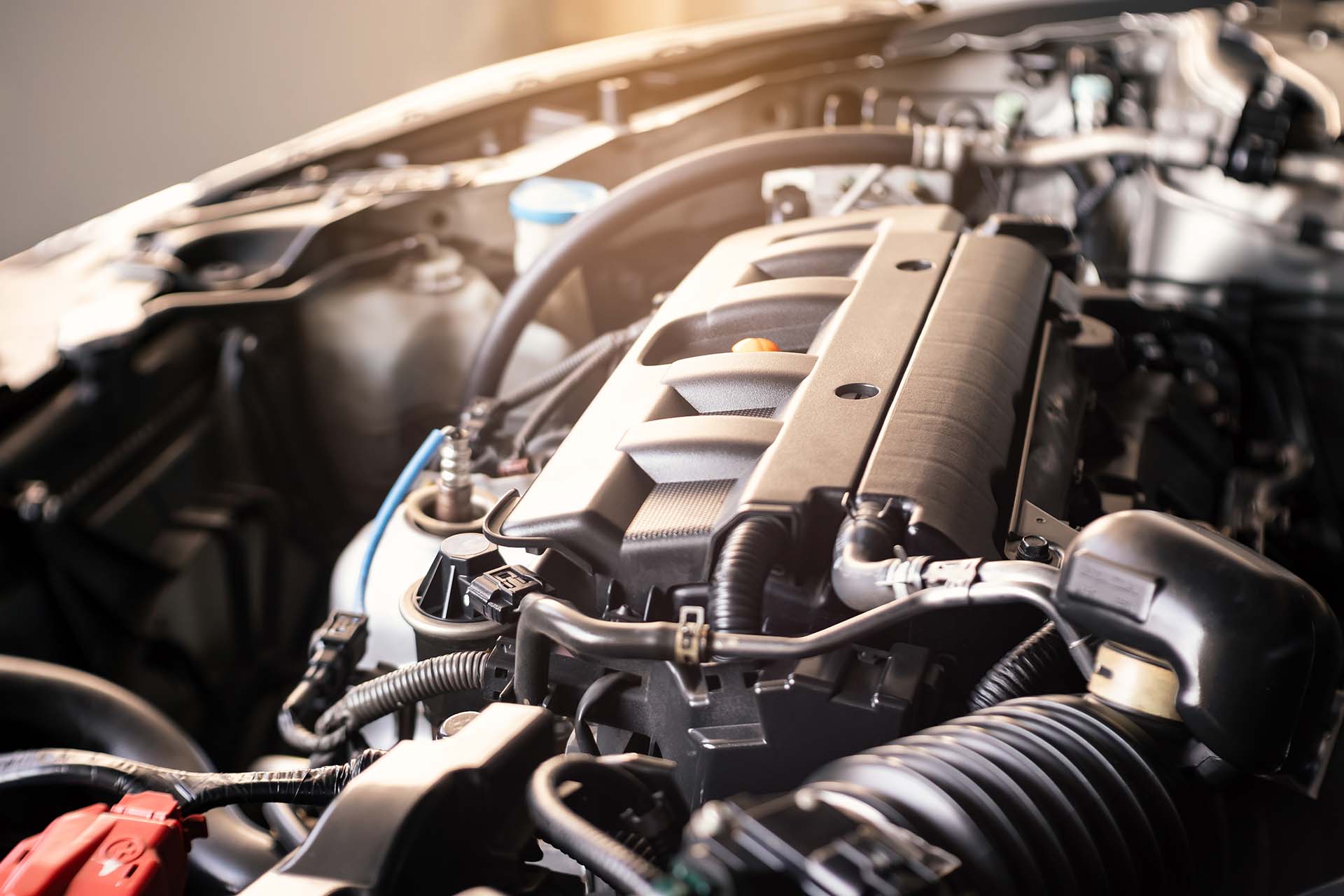 details of modern car engine with sunlight effect, shallow depth of field