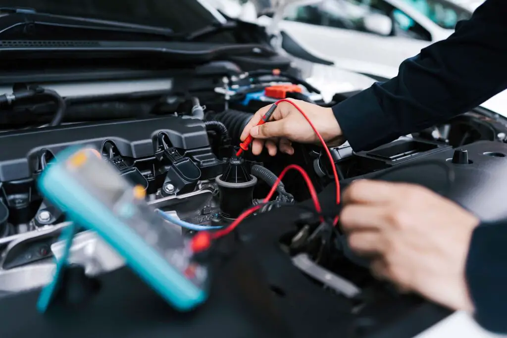 A mechanic testing an electric car battery