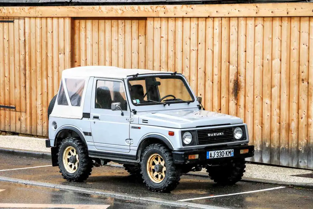 Auvergne-Rhone-Alpes, France - March 15, 2019: Off-road mini SUV Suzuki SJ413 JX in the town street.