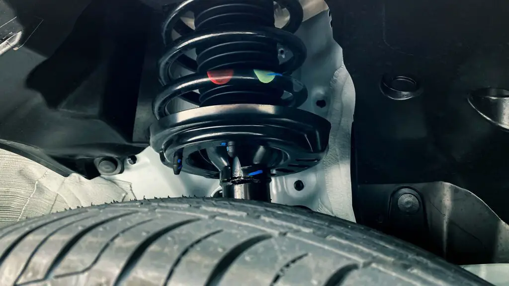 A shock absorber strut with a coil spring