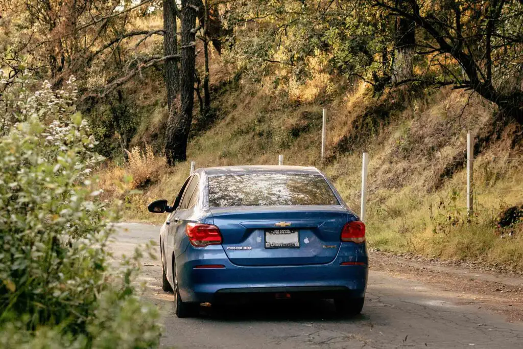 Blue Chevrolet Cobalt driving in the nature