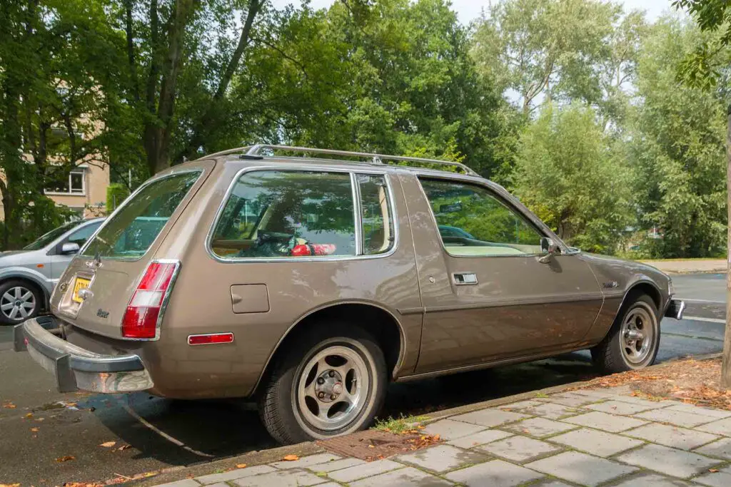 modern classic AMC pacer car parked on a pleasant city street