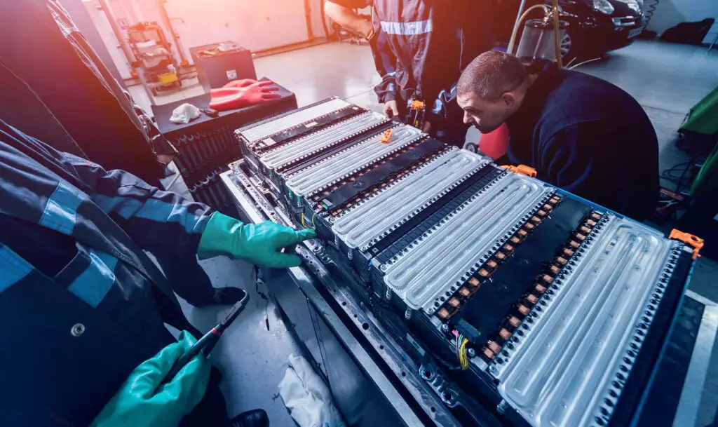 Charging the batteries of the elecric motor. Disassembling the battery of an electric vehicle engine. Car service