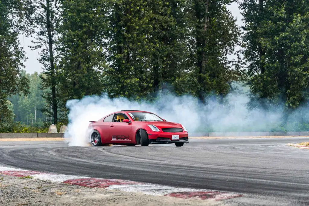 Red Drift Car / Race car drifting around corner very fast with l