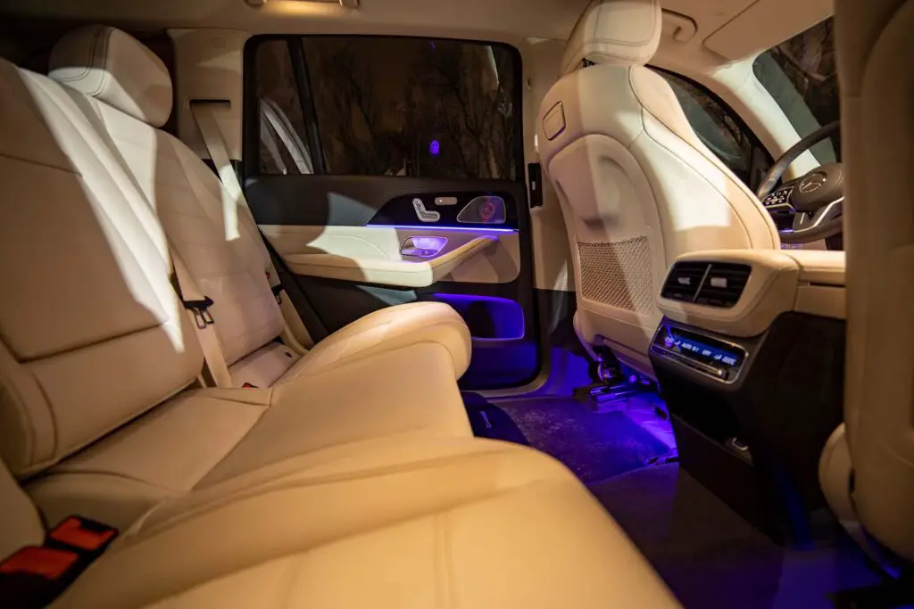 December 24, 2019: Rear row of seats of premium SUV Mercedes GLS class. white luxury leather interior. night photography.