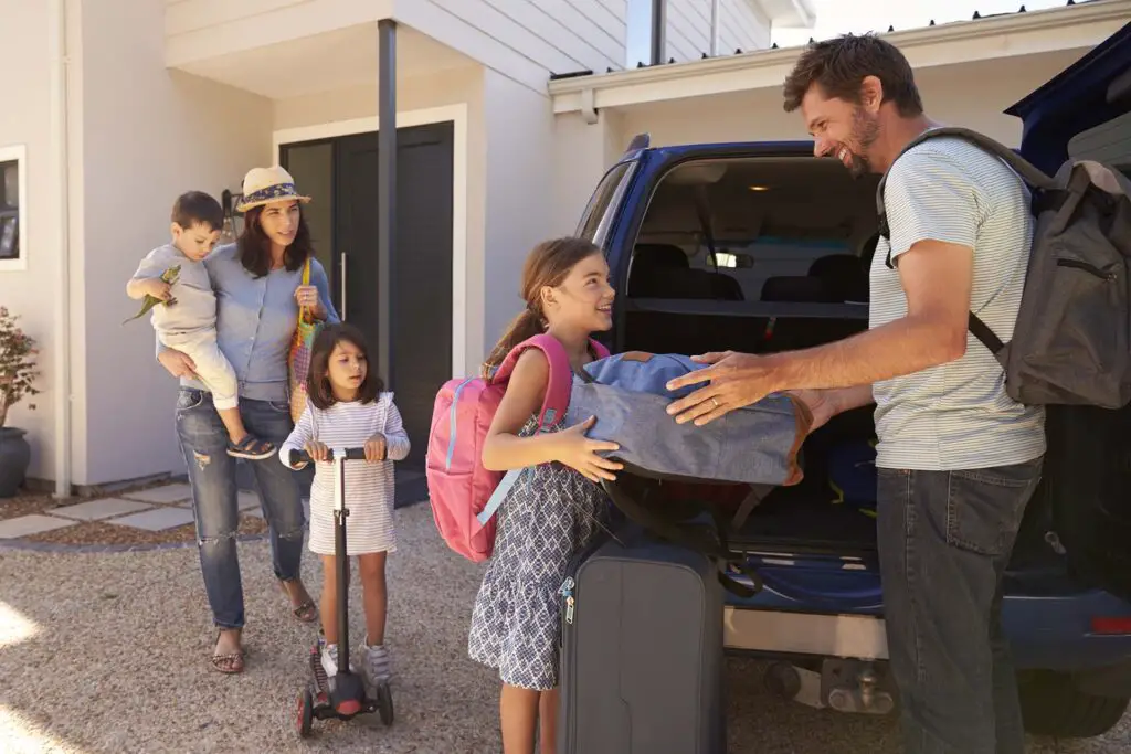 Family packing a car for a road trip