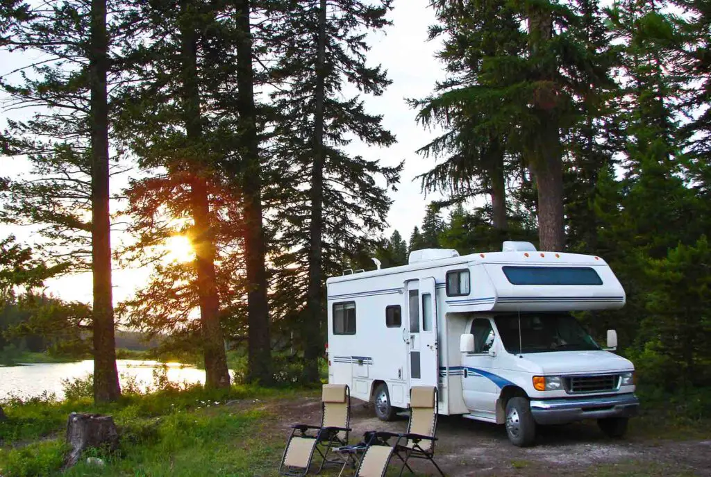 RV in the woods beside a lake