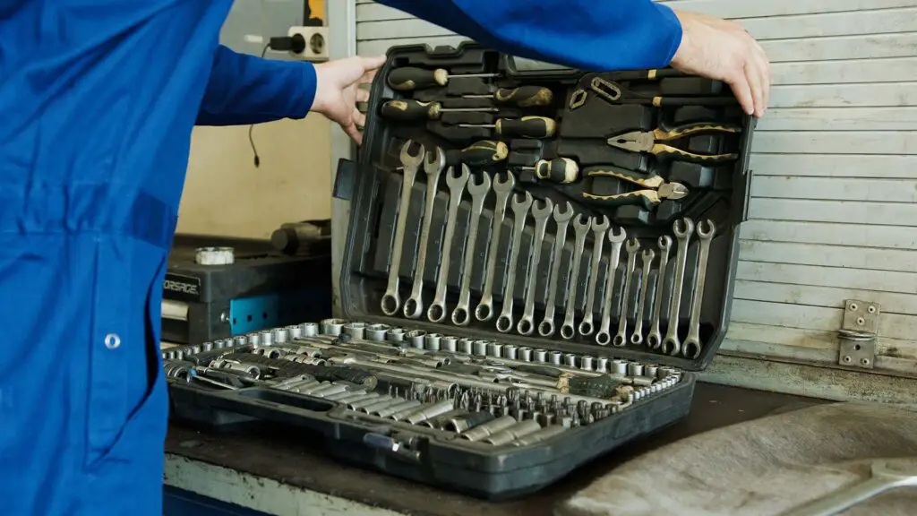 A Person Holding a Set of Tools in a Toolbox