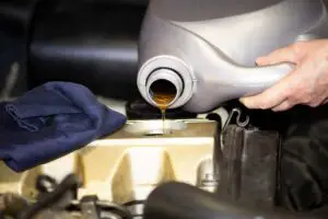A mechanic changing motor oil