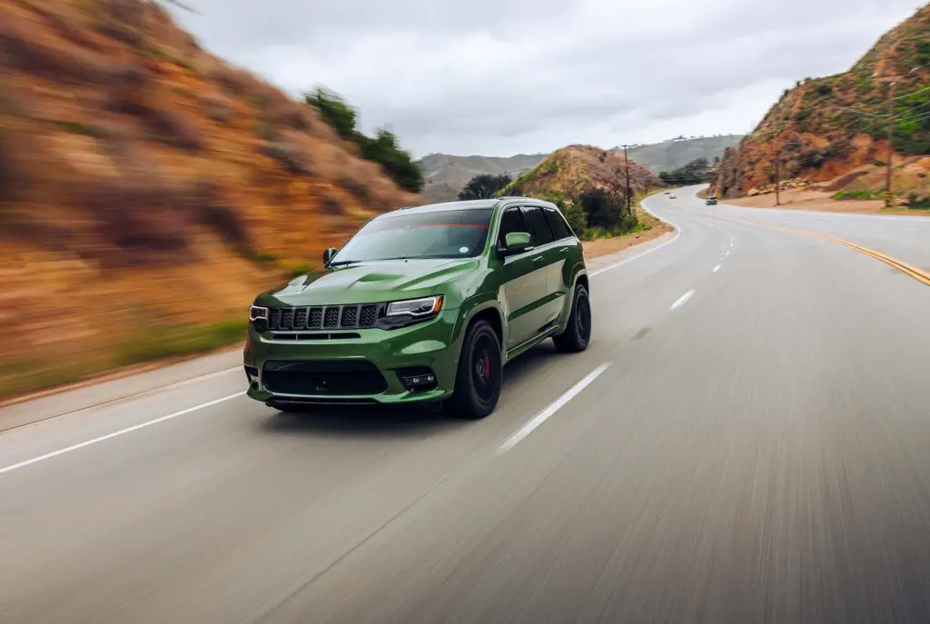 Green Jeep Grand Cherokee on the road