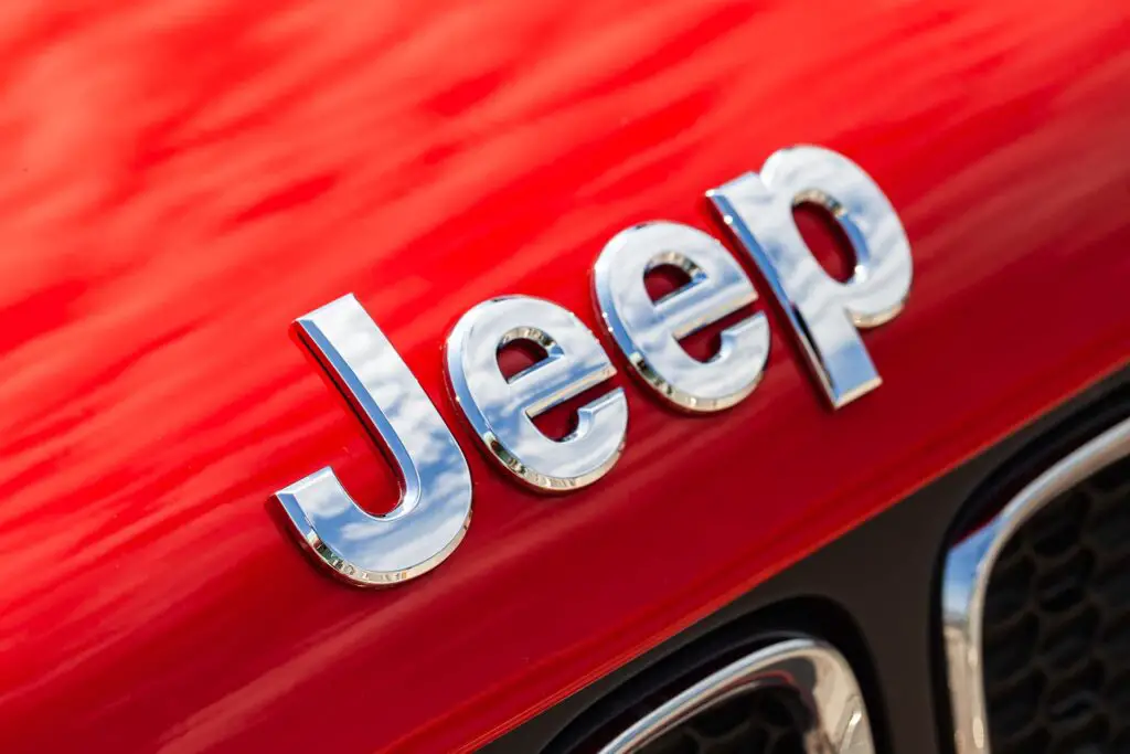 A Jeep emblem on a red car