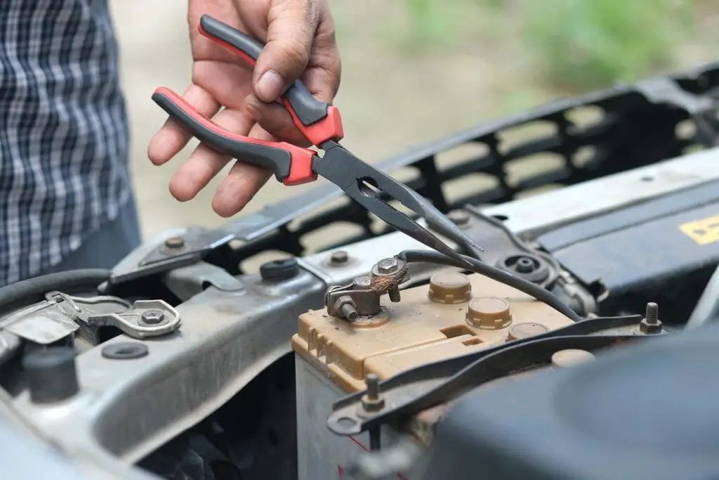 A person installing a car battery