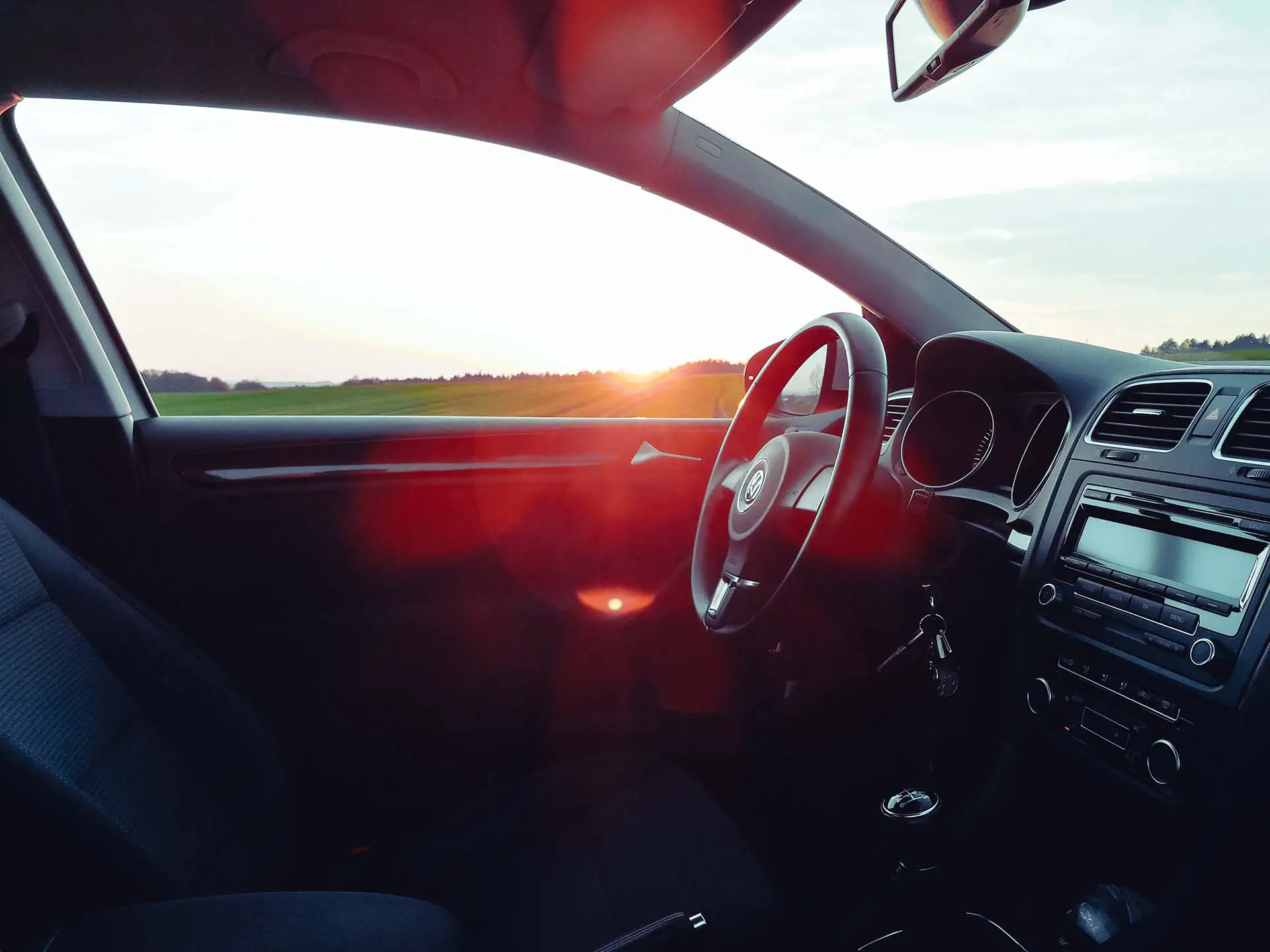 Black car interior during sunset
