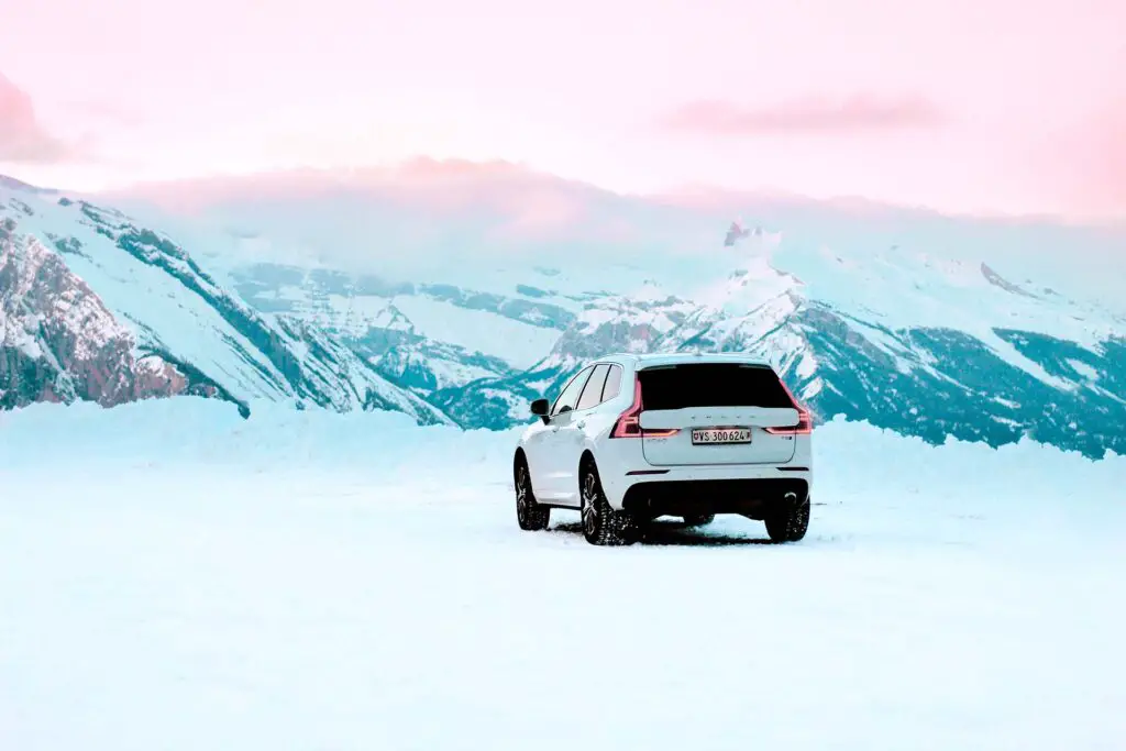 A white car in the snowy mountains
