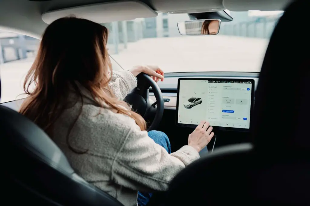 Woman using a Tesla infotainment system