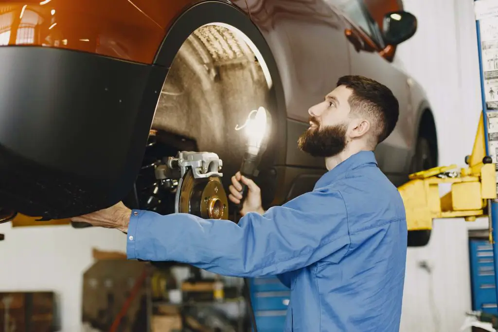 A mechanic checking car brakes