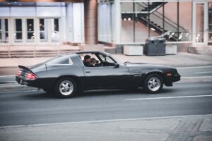 People driving in a 1995 Chevy Camaro