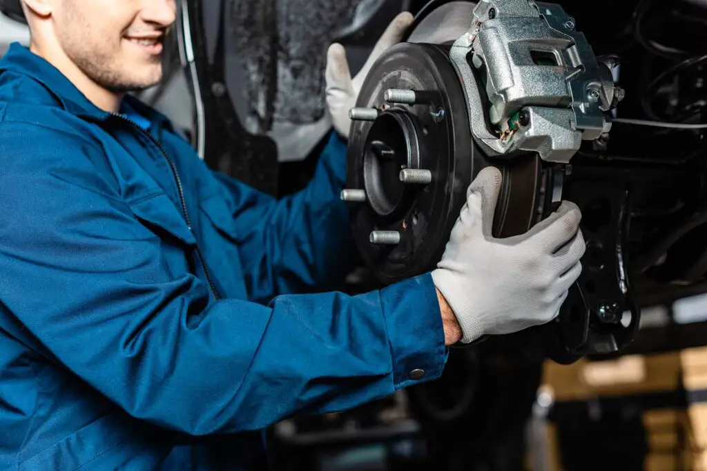 A mechanic adjusting disc brakes