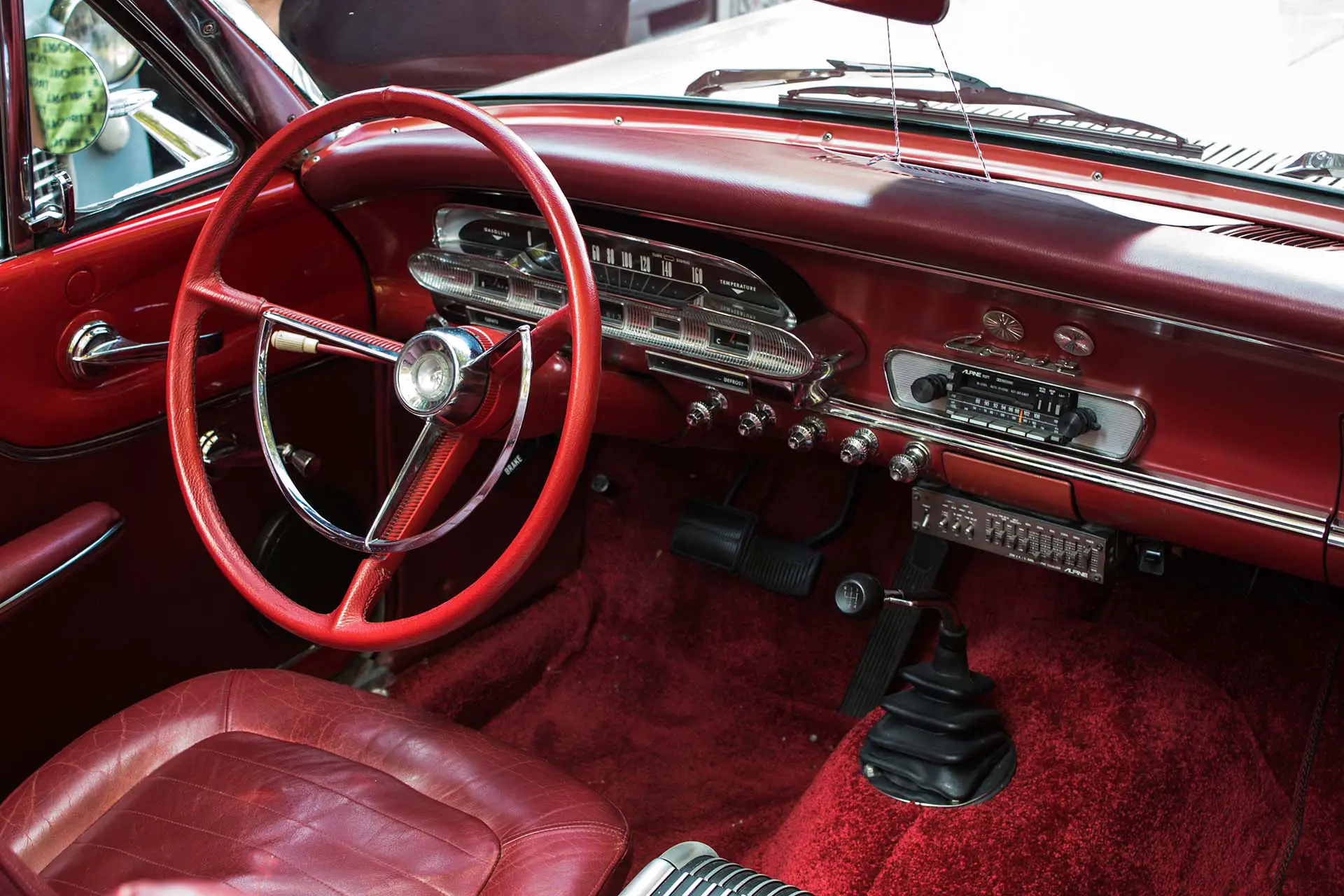 red steering wheel and a car carpet