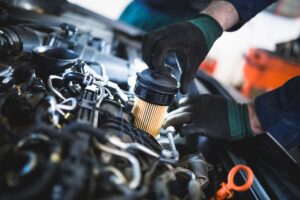 A mechanic replacing the oil filter